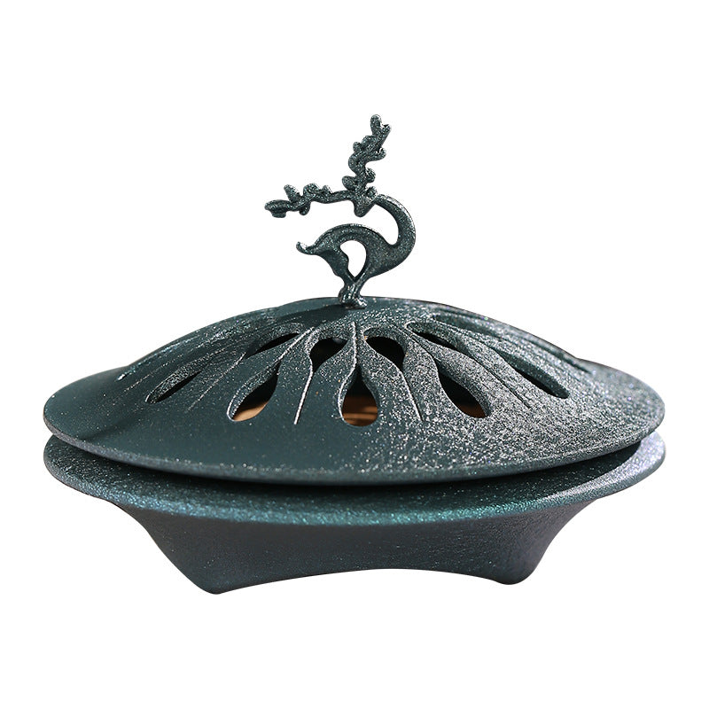 Blue-green metal incense coil burner with sculpted deer and pierced lid