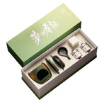 Sage green ceramic incense warmer gift set with two powder jars and illustrated box