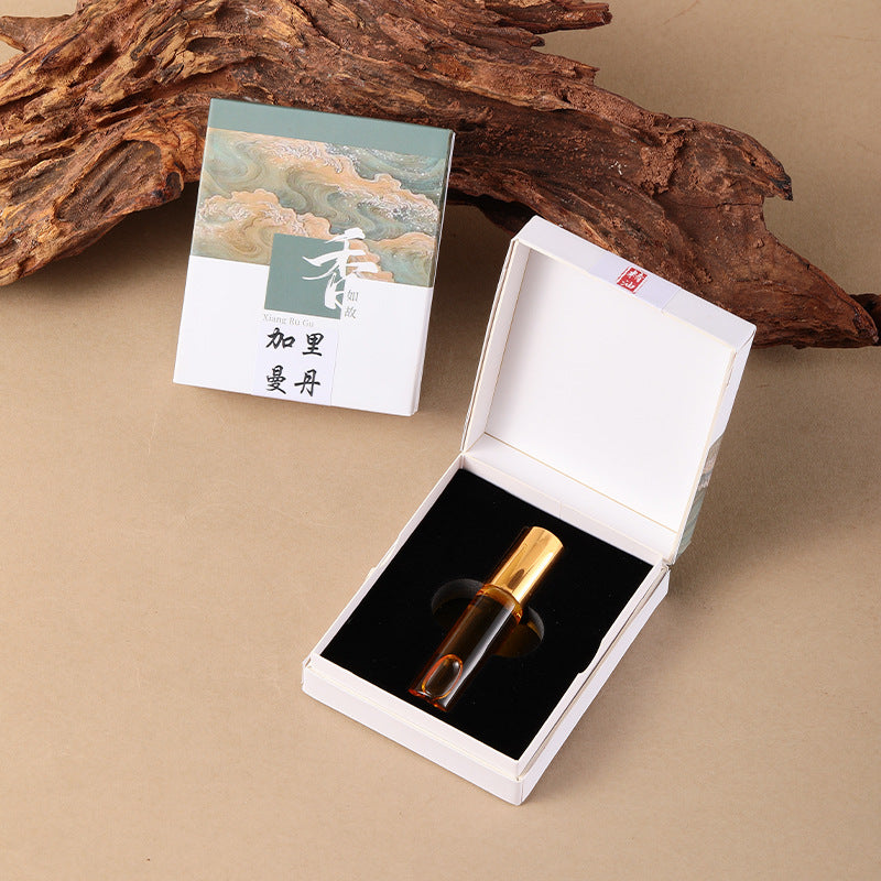Kalimantan fragrance oil bottle in an open illustrated presentation box