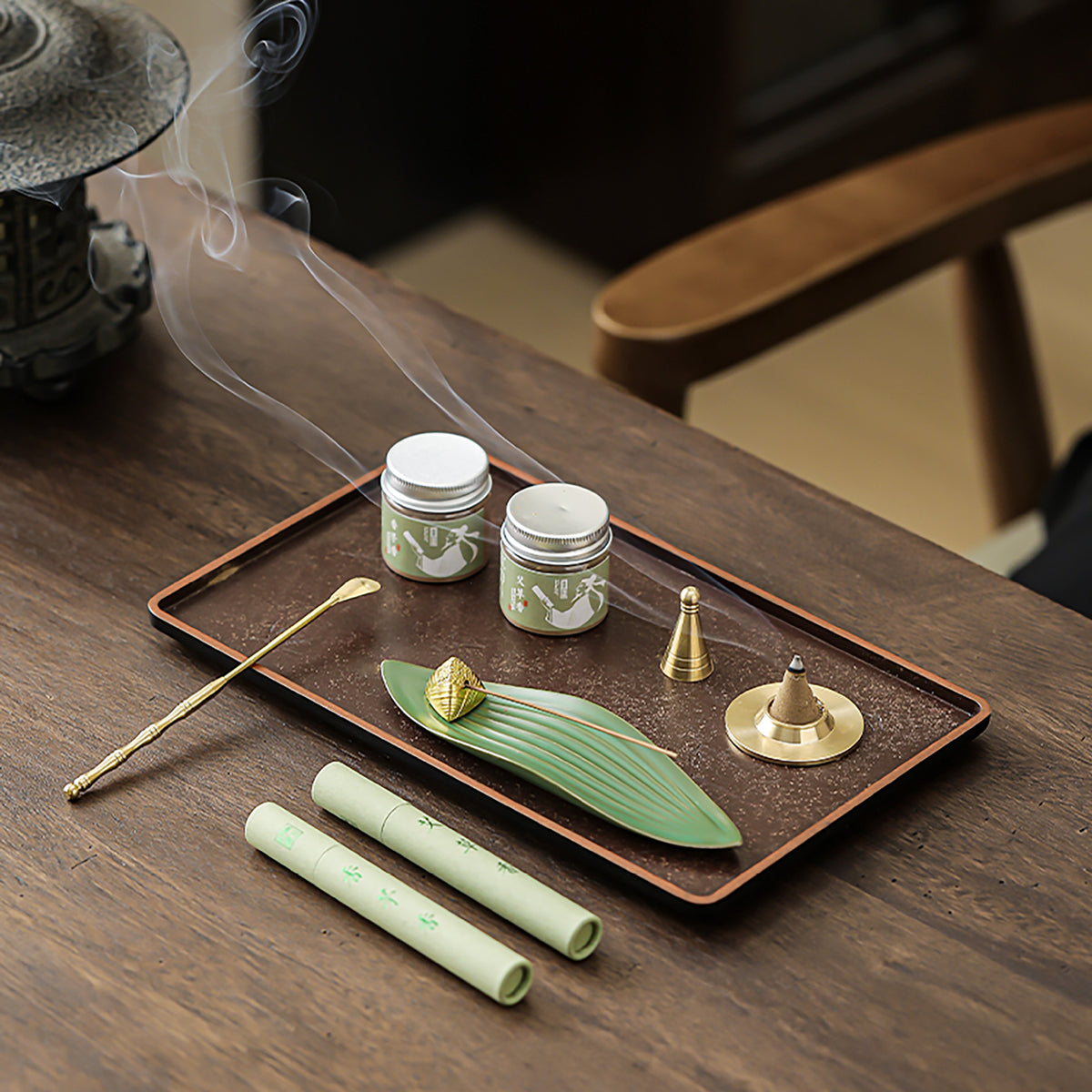 Ceramic leaf holder, incense tubes, powder jars and shaping tools on a display tray; tray not included