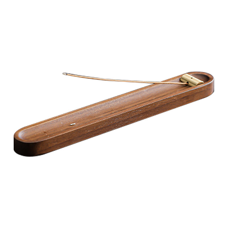 Walnut and brass incense holder on a white background; incense not included