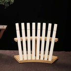 Bamboo display stand holding example incense tubes; tubes not included
