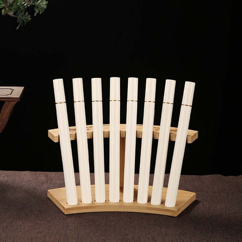 Bamboo display stand holding example incense tubes; tubes not included