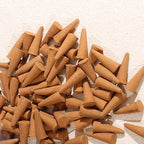 Loose incense cones on a warm textured surface