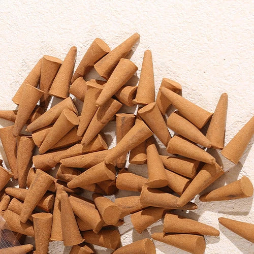Loose incense cones on a warm textured surface