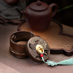 Brass incense burner open with the lid beside it