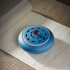 Top view of the pierced lotus lid and red bead knob