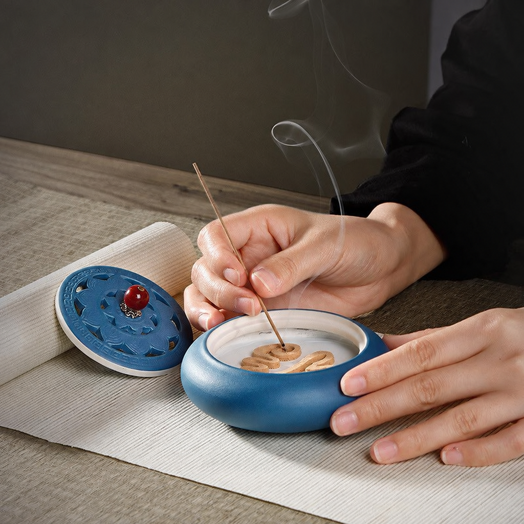 Blue ceramic burner with the lid removed, showing a powder incense arrangement