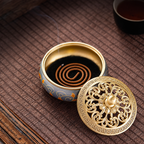 Open brass incense burner with a coil and the lid placed beside it