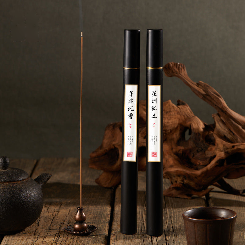 Black incense tubes in a styled setting