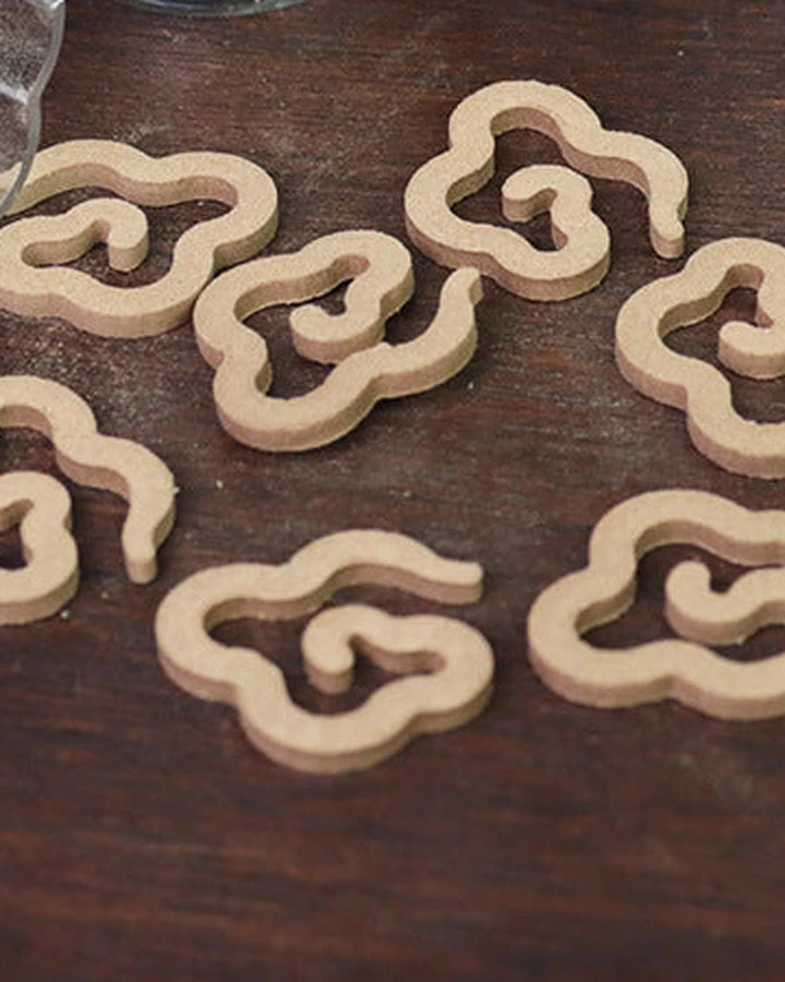 Mini cloud-shaped incense coils on a dark wooden table